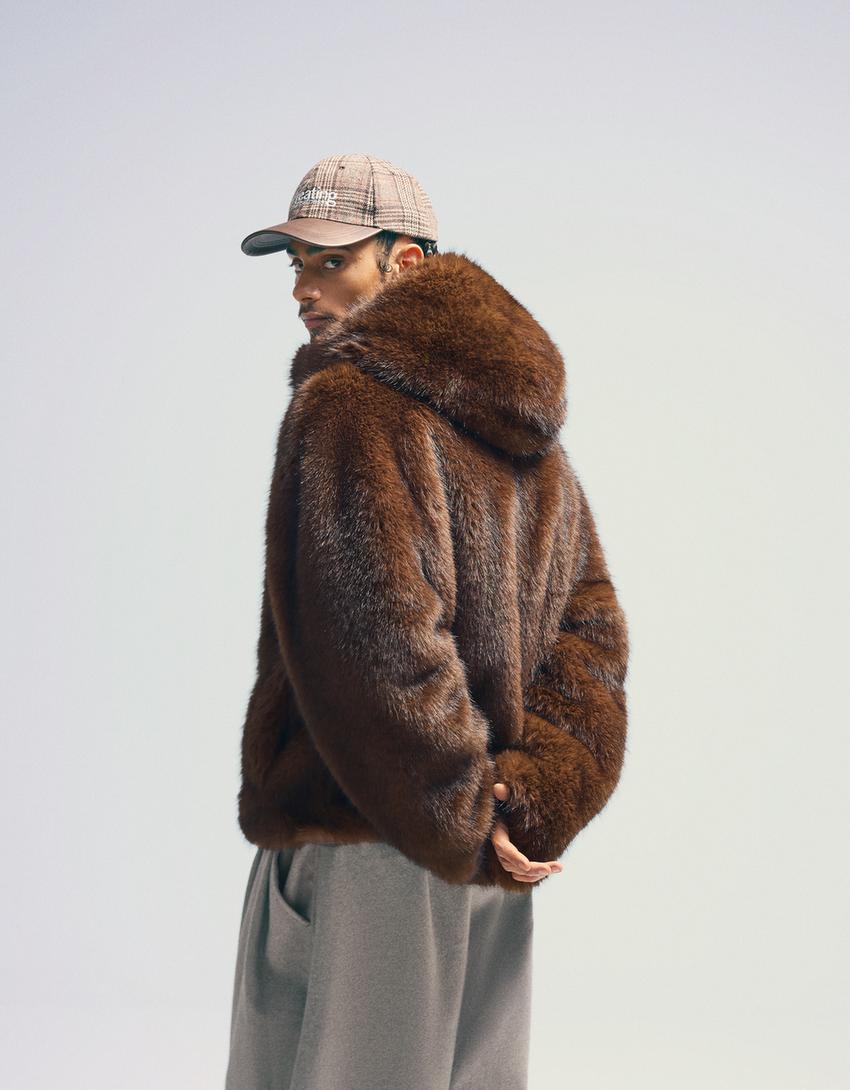 Blouson fausse fourrure à capuche